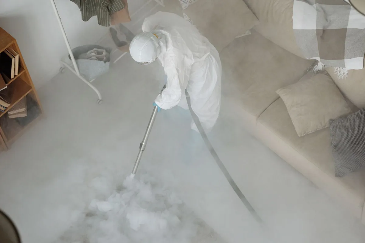 Biohazard cleanup technician in protective equipment, The Pinery, CO